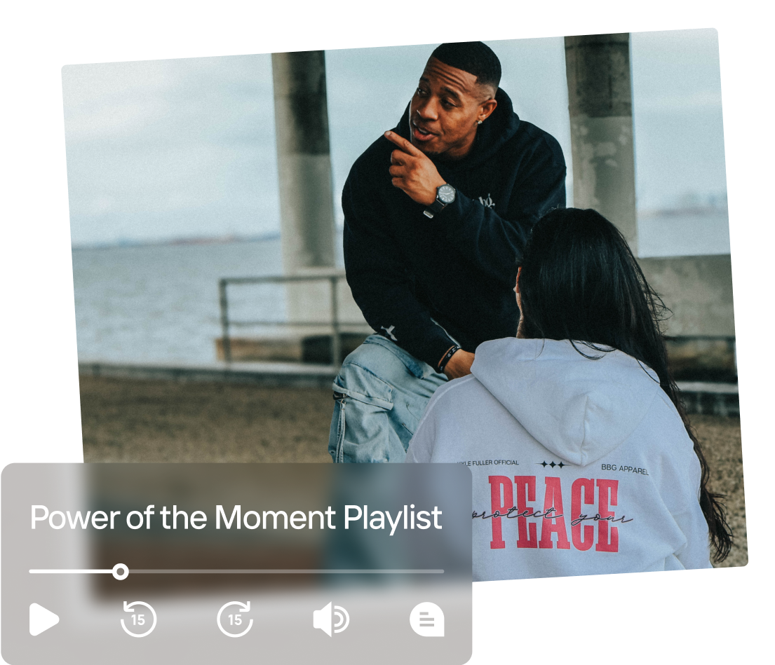 Kyle Fuller sits with a coaching client near the water.