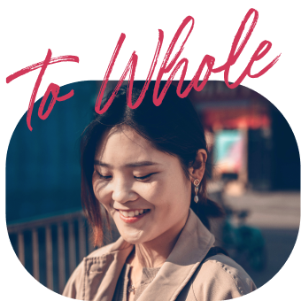 Woman smiling softly in a blue-toned setting.